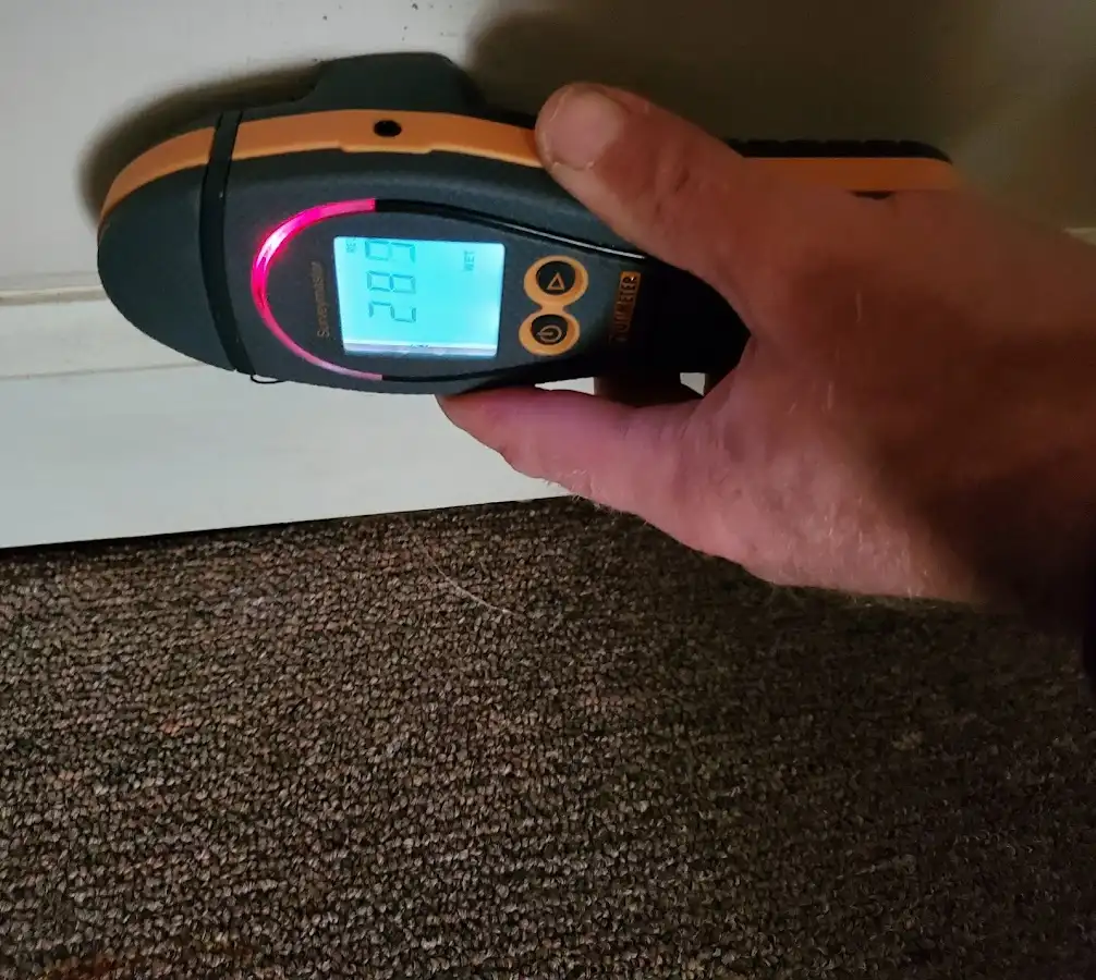 Moisture detection at baseboard during Storm Damage Restoration in Sparks